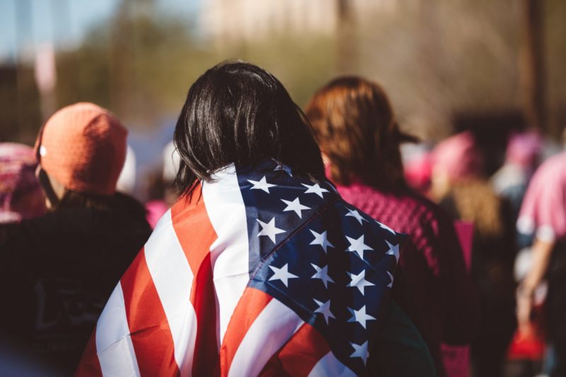The American flag draped across a woman